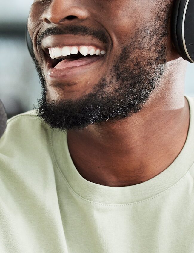 Black man, microphone and mouth with headphones and radio DJ, news with communication and audio equ