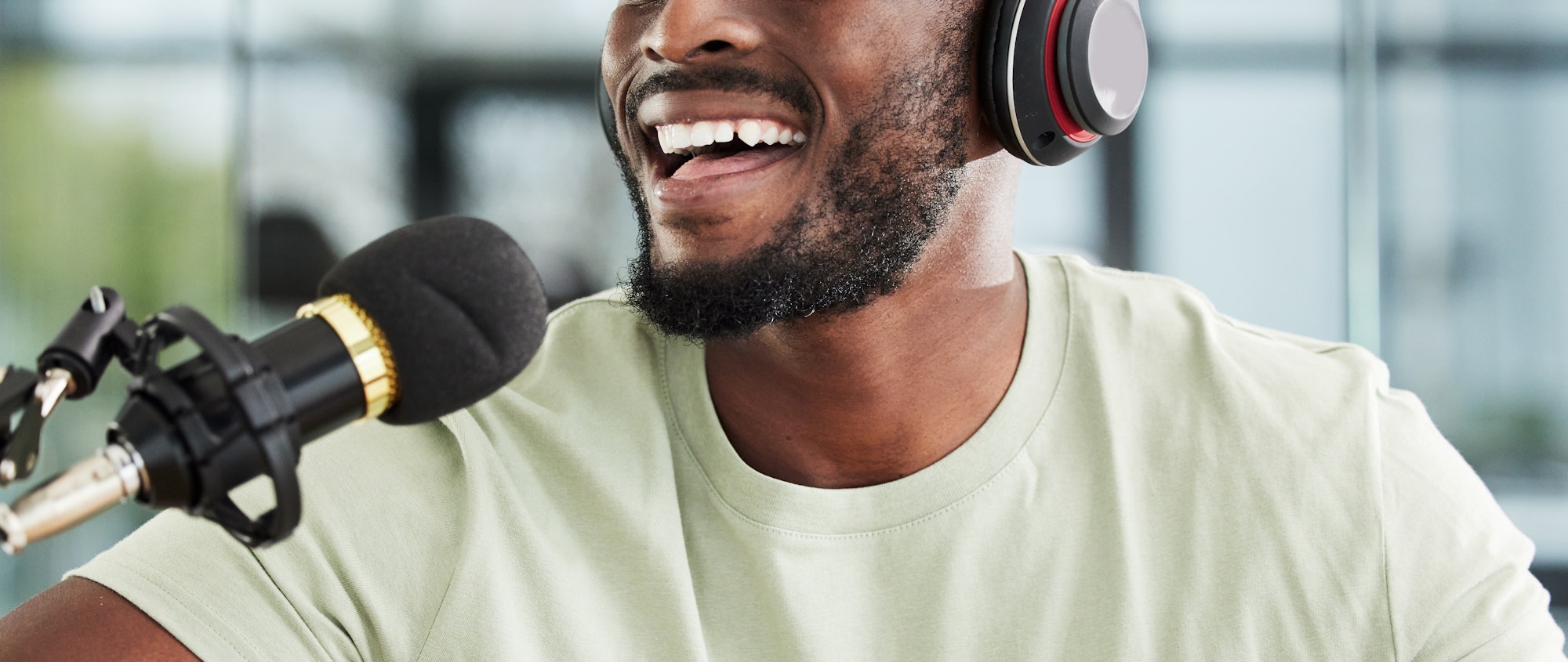 Black man, microphone and mouth with headphones and radio DJ, news with communication and audio equ